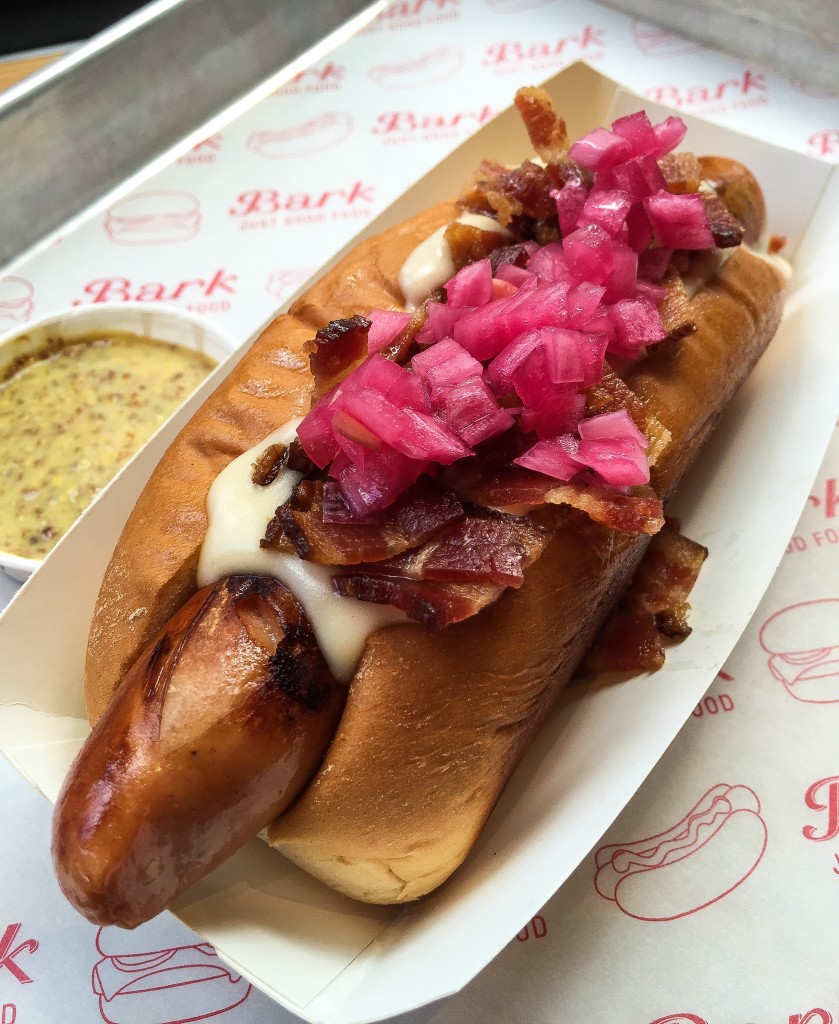 BACON-CHEDDAR DOG  Nueske’s bacon, Bark Grafton cheddar sauce and pickled red onions