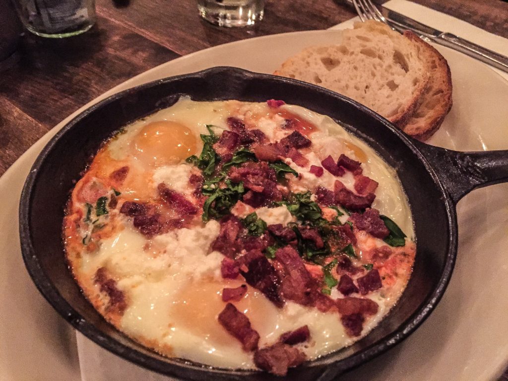 Baked Skillet Eggs Shakshuka  spinach, feta cheese, tomato-bell pepper sauce, buttered sourdough toast - $14