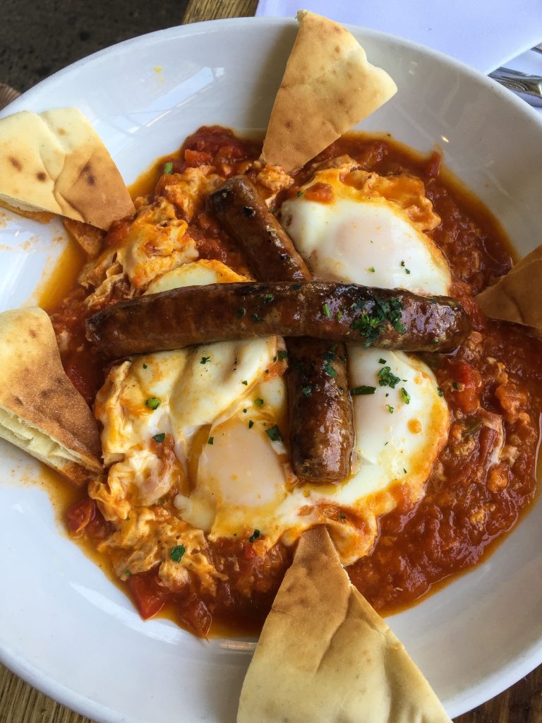 SHAKSHUKA MOROCCAN BREAKFAST three eggs baked with tomato, onion, pepper, spices, tahini, pita 14 add merguez sausage 5