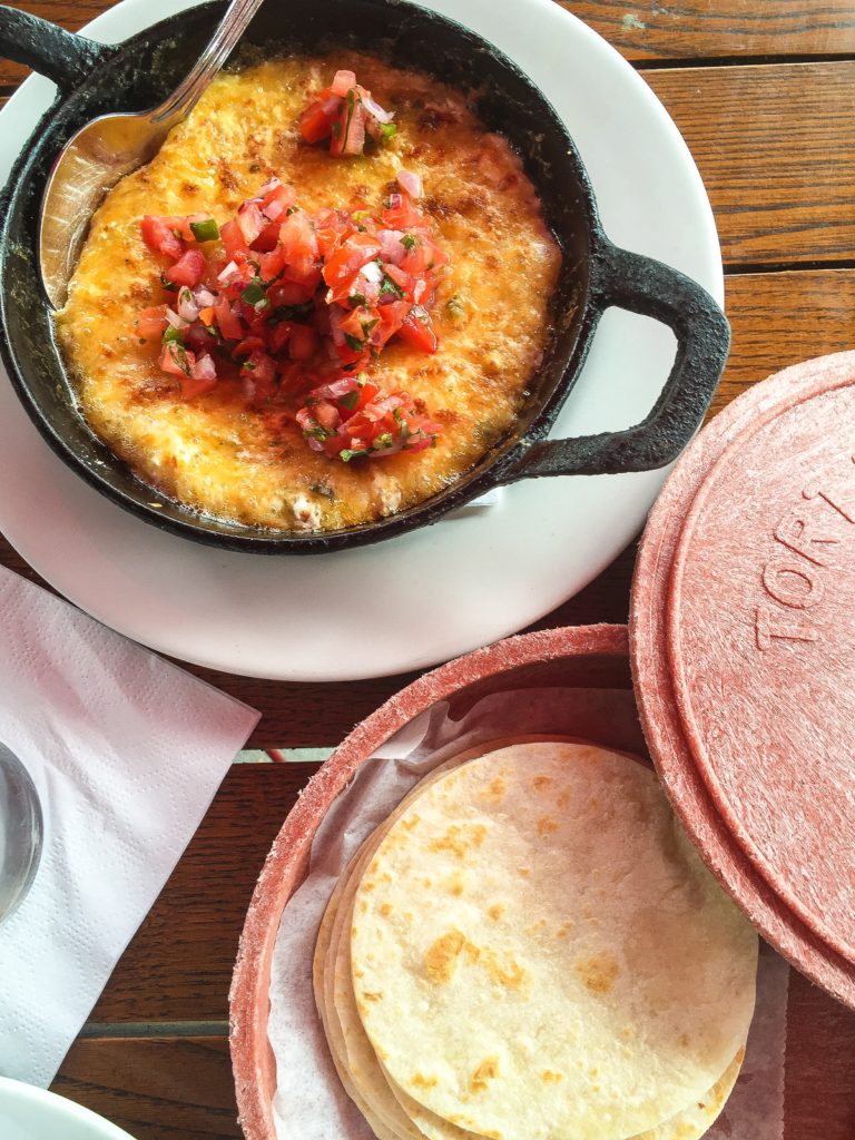 GREEN CHILE QUESO FUNDIDO  mexican cheese & green chile fondue, warm flour tortilla -  $12