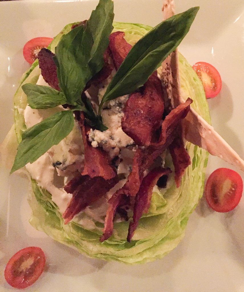 WEDGE OF ICEBERG LETTUCE CRUMBLED BLUE CHEESE, CRISPY BACON 15.5