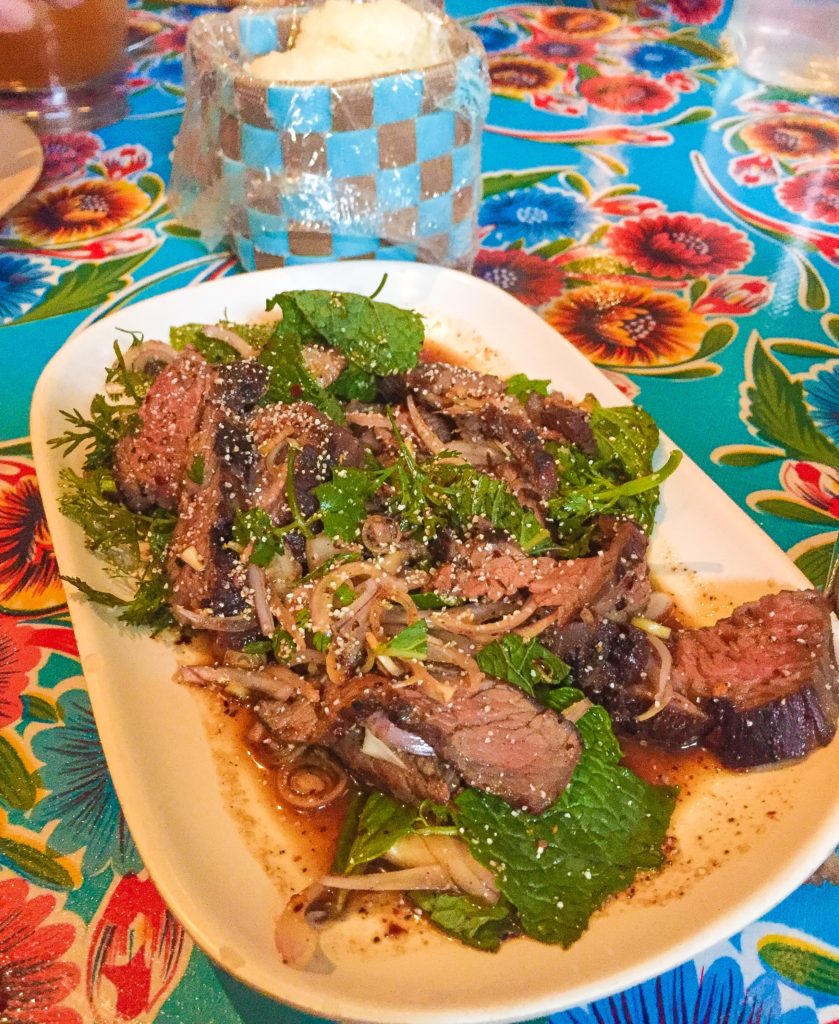 Neua Naam Tok  18 Spicy Isaan flank steak “salad” with fish sauce, lime and chili powder dressing, shallots, lemongrass, mint, cilantro and toasted rice powder. You’ll want to get some sticky rice, it’s hot. Try it with Beer Lao!